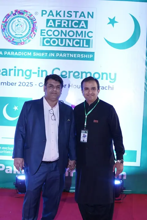PAC members photographed at the official ceremony backdrop.